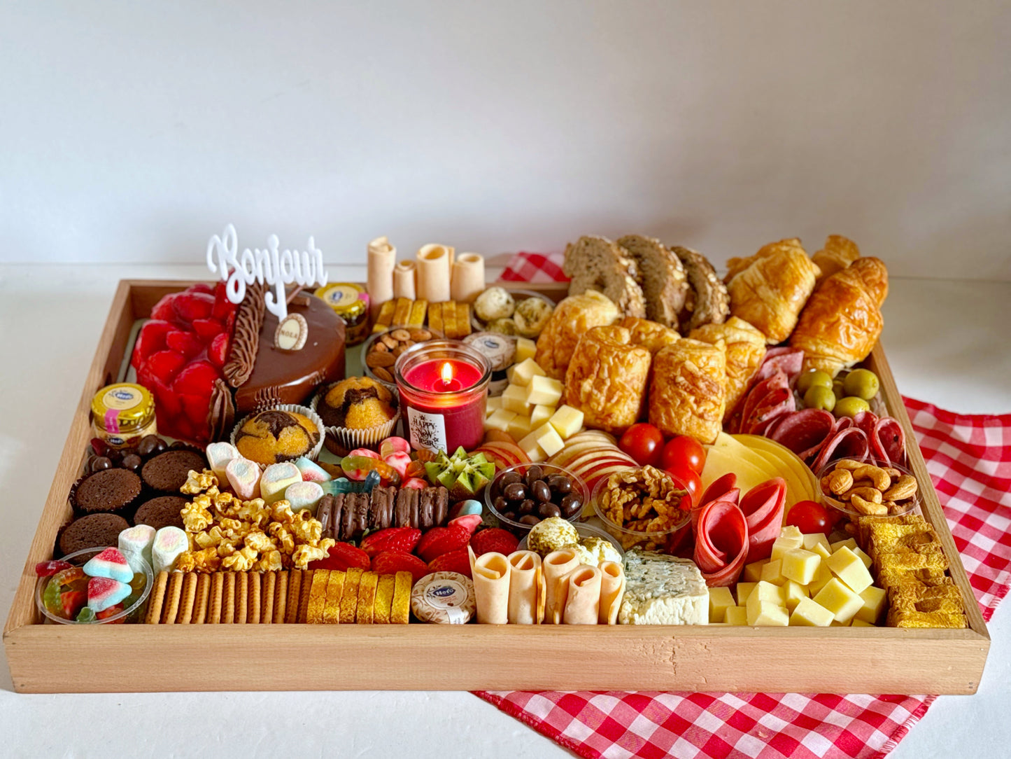 A stunning gourmet family platter arranged with fresh ingredients, showcasing a mix of breads, cheeses, spreads, fruits, nuts, and indulgent treats for a perfect gathering.