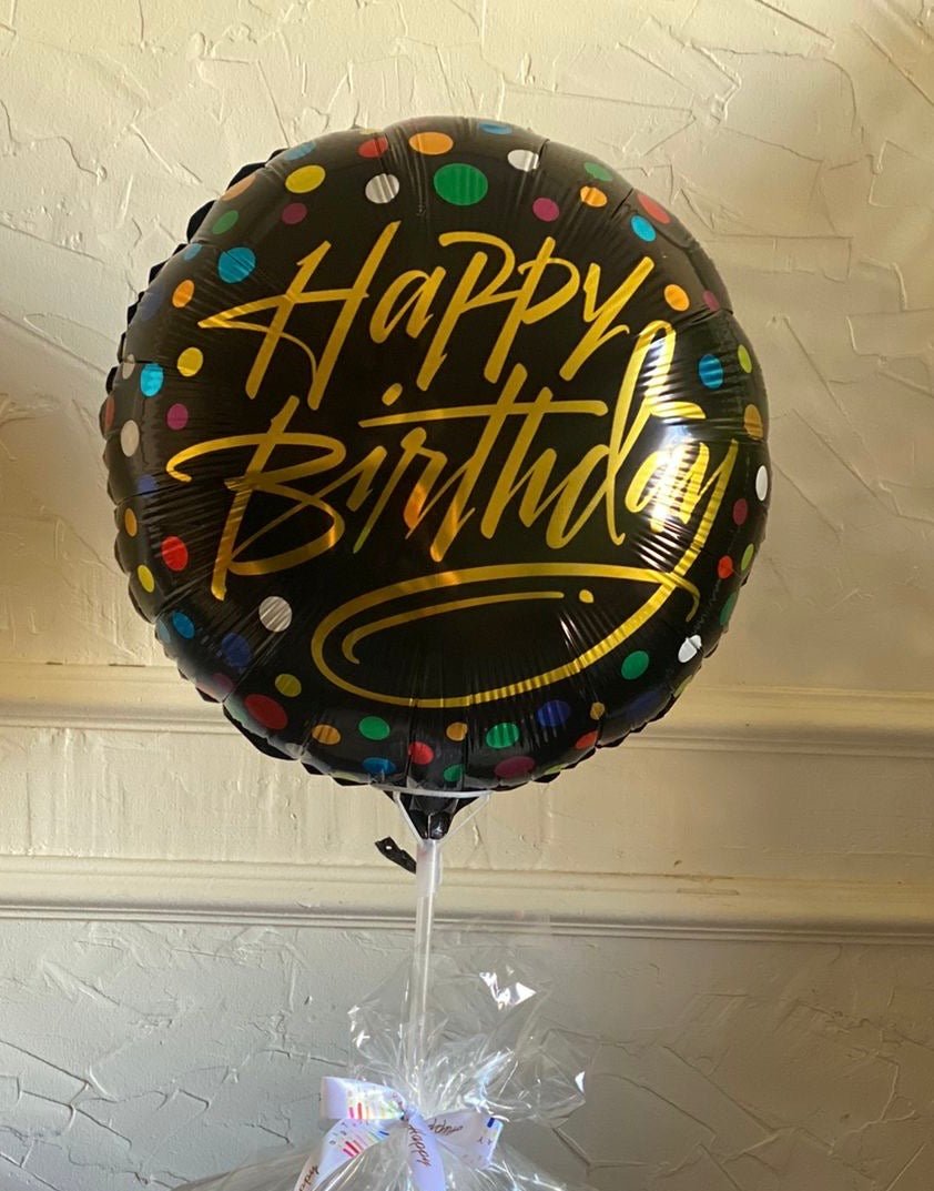 A black Happy Birthday balloon with golden text and multicolored polka dots, designed to bring a stylish and celebratory feel to any birthday occasion.
