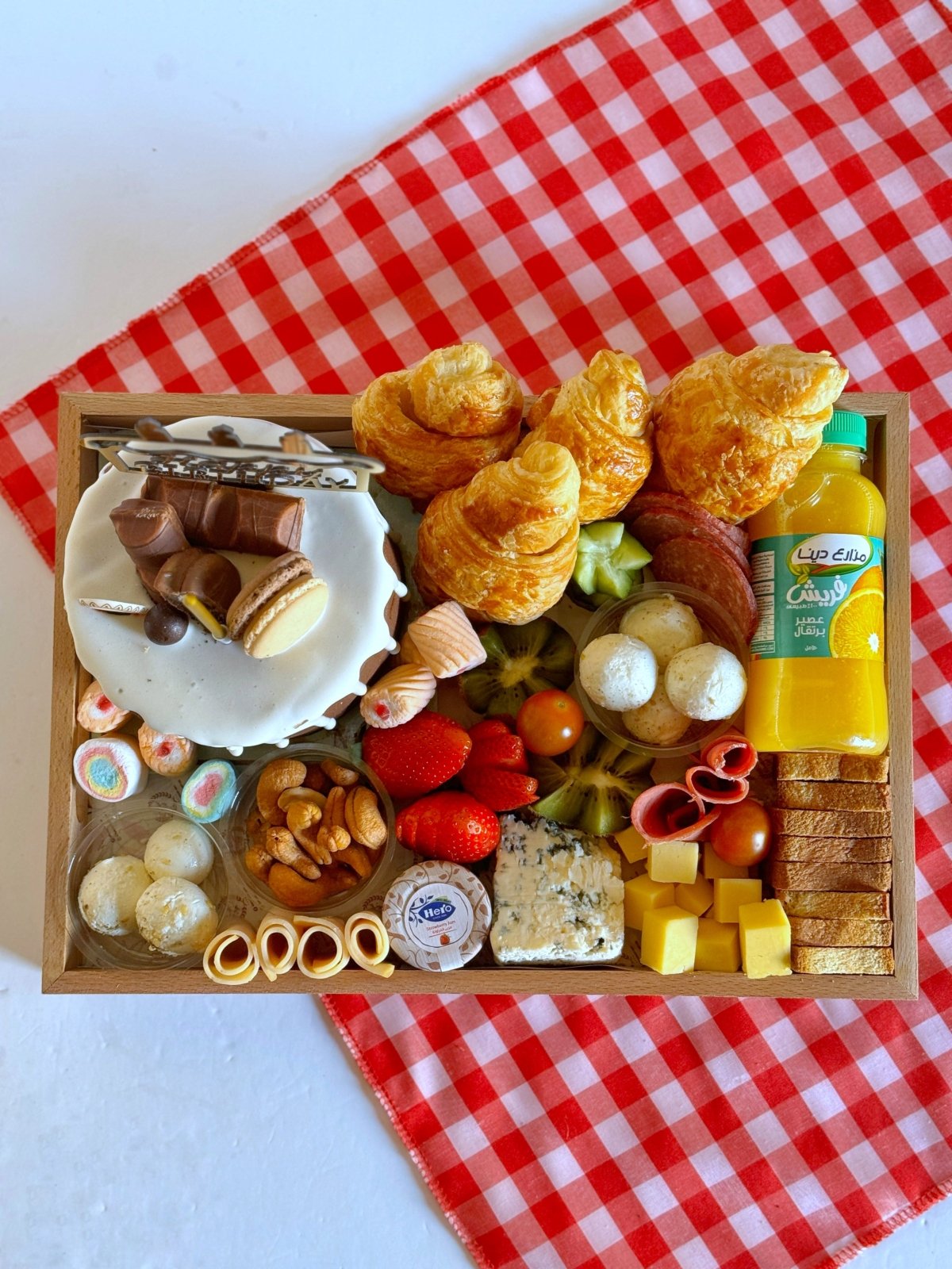 A top-down shot of the birthday breakfast tray showcasing an elegant mix of pastries, fresh fruits, cheese, and deli meats, making it an ideal birthday gift.