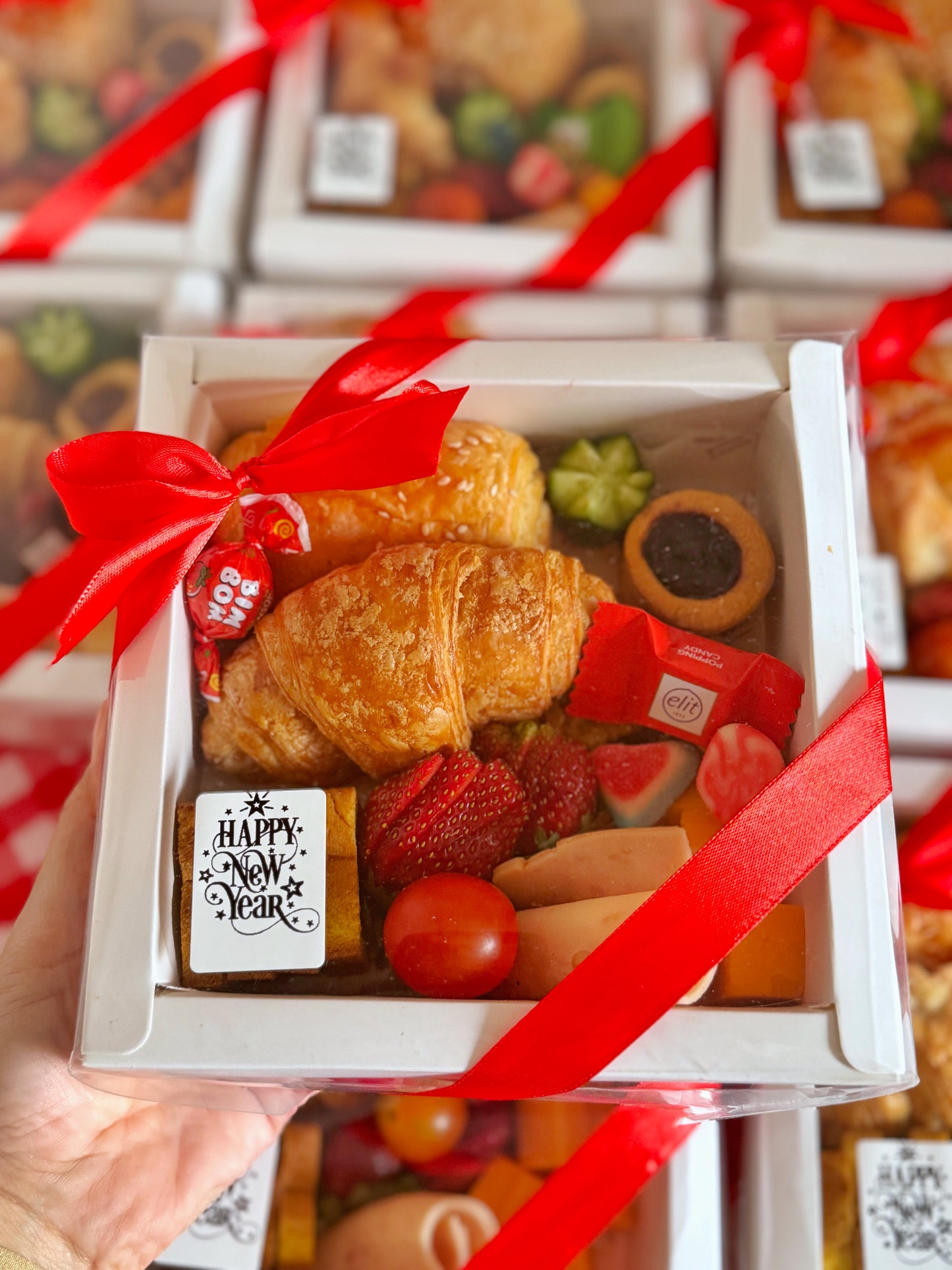 A beautifully arranged Corporate Gift Box featuring a freshly baked croissant, a cheese-filled pâté, mini toasted bread, turkey slices, cheddar cheese, and an assortment of sweets, elegantly packaged for corporate gifting.