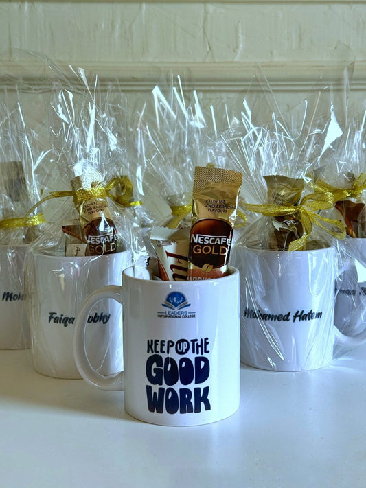 Multiple branded mugs arranged together, filled with drink sachets and wrapped with golden bows—ideal for corporate or school gifting.
