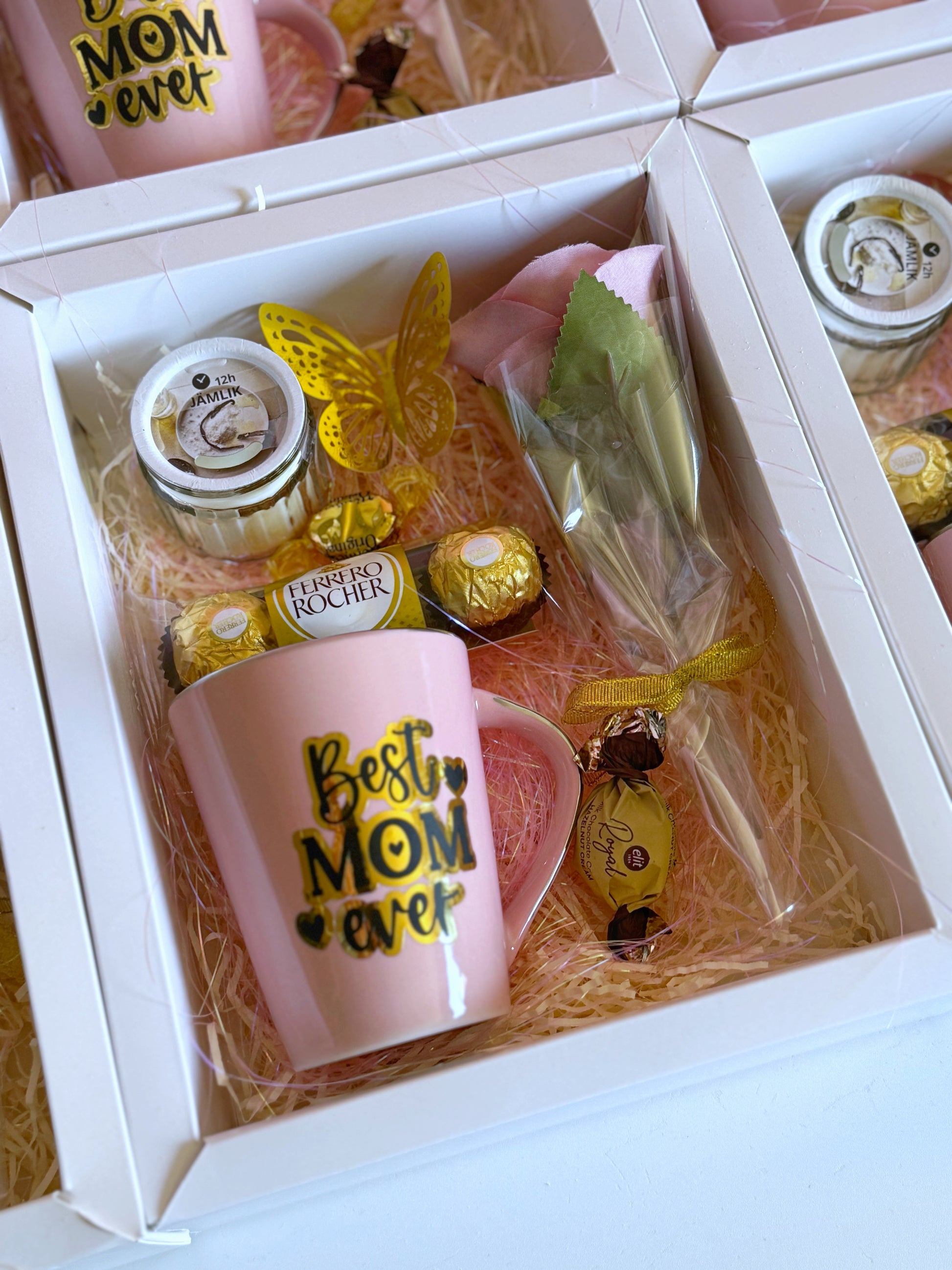 A close-up of the Best Mom Ever Surprise Box, highlighting the gold-accented pink mug, luxurious chocolates, and delicate decorations inside the white gift box.