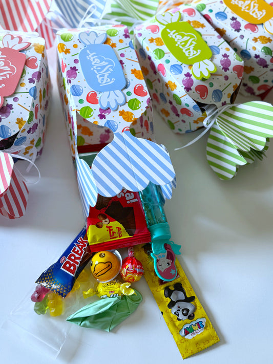 A collection of Eid Bonbon Boxes in pink, green, blue, and orange, shaped like wrapped candies.