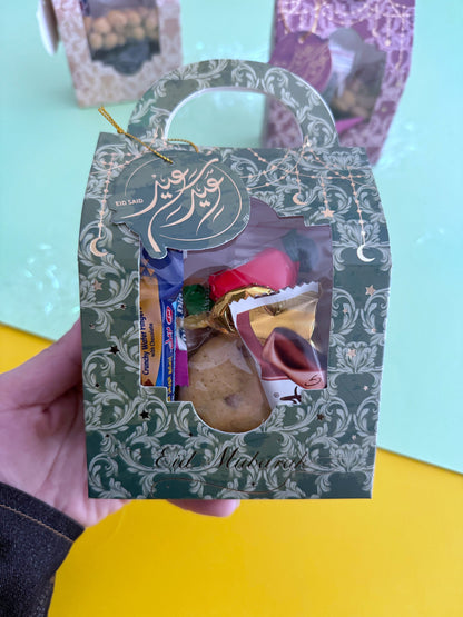 Eid Elegance Box – Golden Patterns – Close-up of box held in hand showing sweets packed inside through window