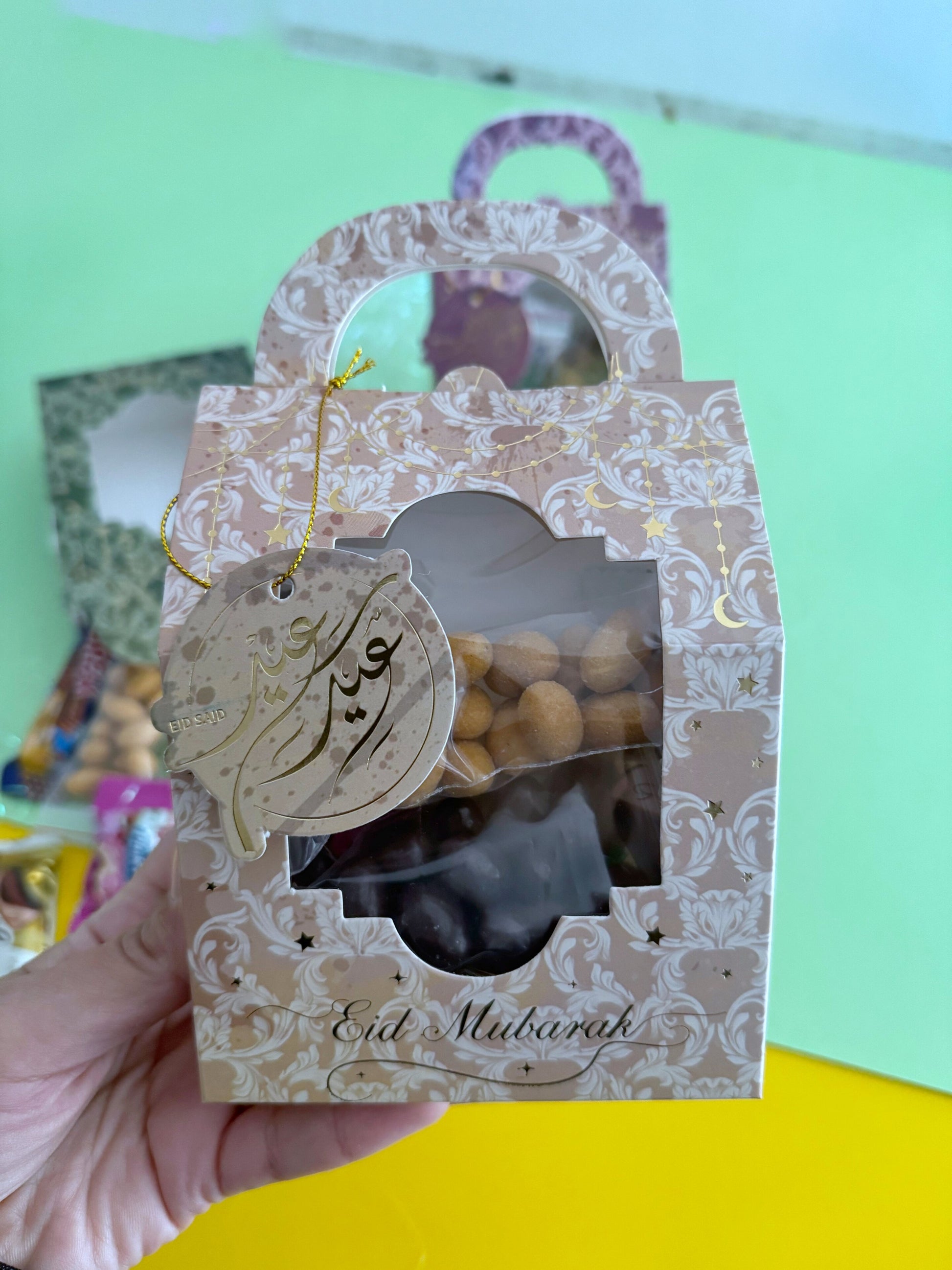 Eid Elegance Box – Pink Patterns – Front view of closed gift box held in hand with Eid Said tag