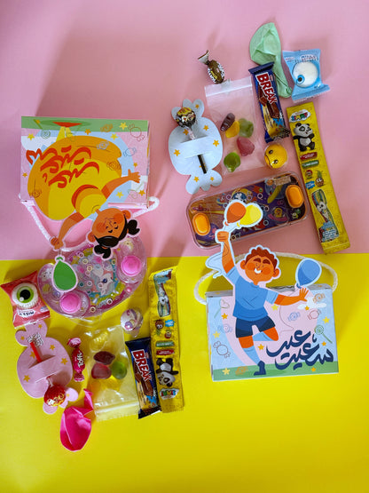 A top-down view of the Eid Joy Bag’s contents, featuring chocolates, gummies, a water toy, and a festive design.