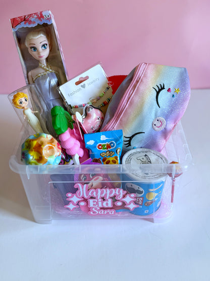 Eid Princess Box - Girl featuring a Frozen doll, unicorn bag, bouncing ball, Pringles, sweets, and toys in a personalized transparent Eid gift box.