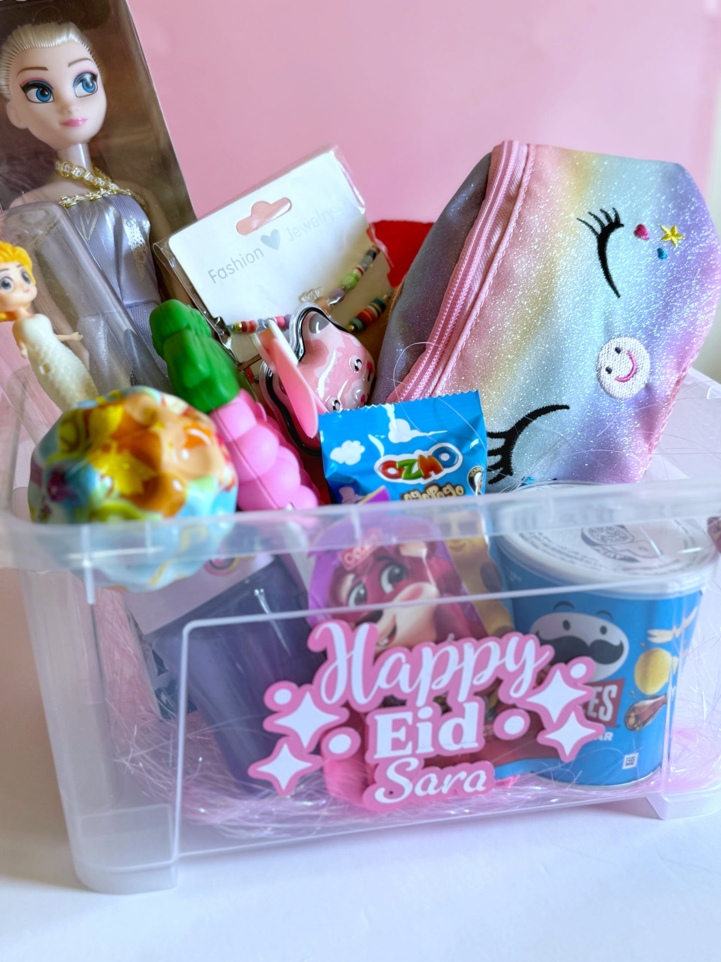 Close-up of the Eid Princess Box - Girl with a unicorn-themed crossbody bag, Frozen doll, bubble blower, and a selection of Eid sweets and toys.