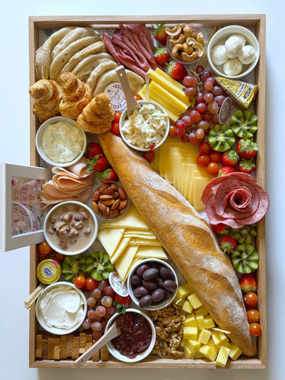 Overhead view of the Family Suhoor Mother’s Day Gift Tray, displaying a rich variety of cheeses, nuts, and breads.