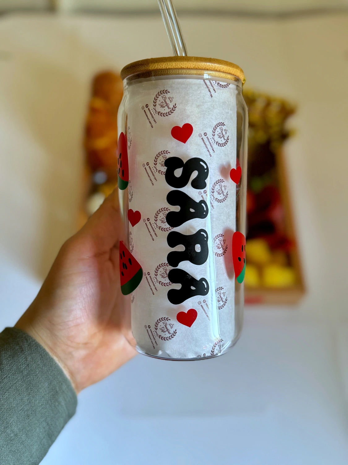 Personalized clear glass with bamboo lid printed with hearts and watermelon designs, labeled "Sara".