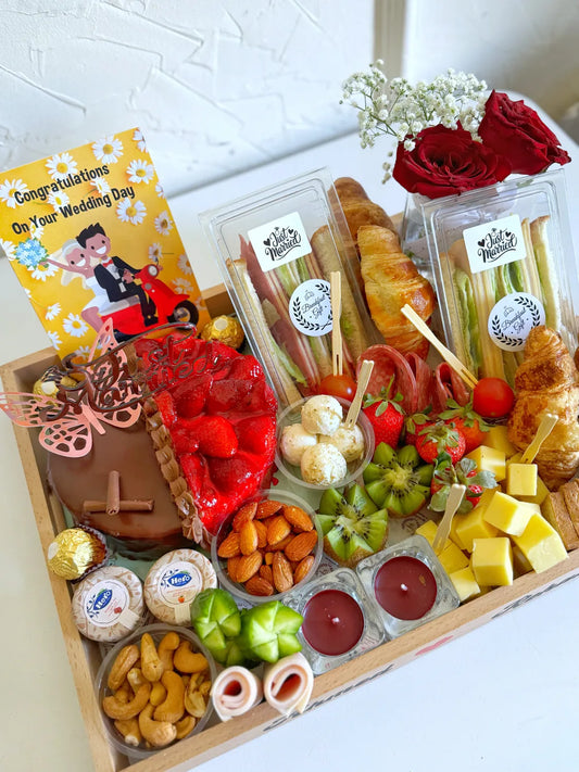 A romantic breakfast tray featuring “Ahmed ❤️ Rehab,” with candles, fruits, cold cuts, and a personalized wedding balloon.