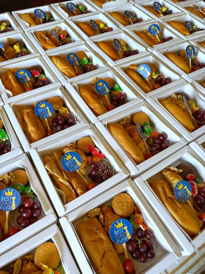 Multiple Little Cheers Boxes displayed on a kids' birthday table setup with balloons and personalized name stickers on each box.