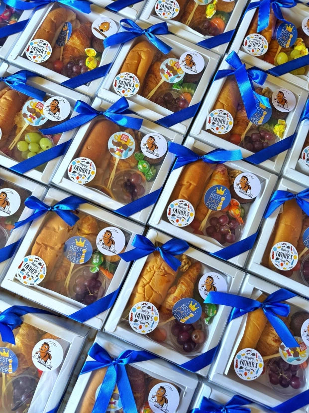 Stacked Little Cheers Boxes ready for bulk delivery, showing consistent branding and colorful packaging for corporate or school events.