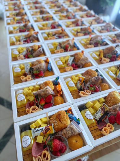 Premium Box – Close angled shot of multiple Premium Boxes showing cheese cubes, croissant, chocolates, and cold cuts
