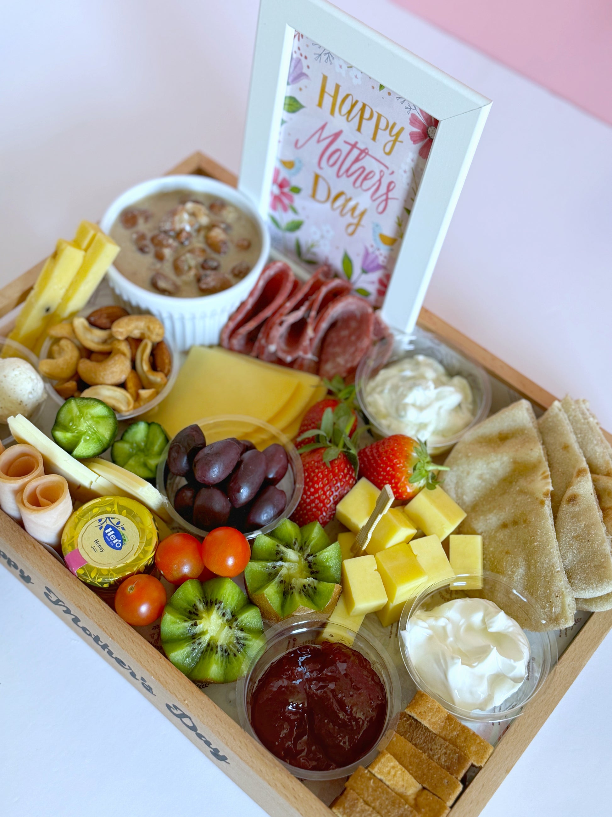 Close-up of the Sohour Mother’s Day tray highlighting gourmet cheeses, salami, smoked turkey, and fresh fruits.