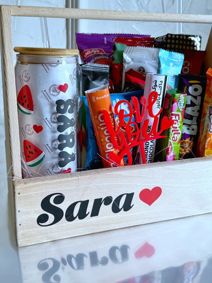 Angled shot showing the variety of snacks and chocolates inside the wooden gift crate, with a “Love You” topper and colorful wrappers.
