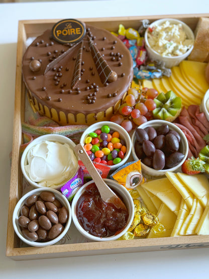Close-up of the chocolate cake, cream cheese, jam, Skittles, and chocolate peanuts in The Celebration Tray.