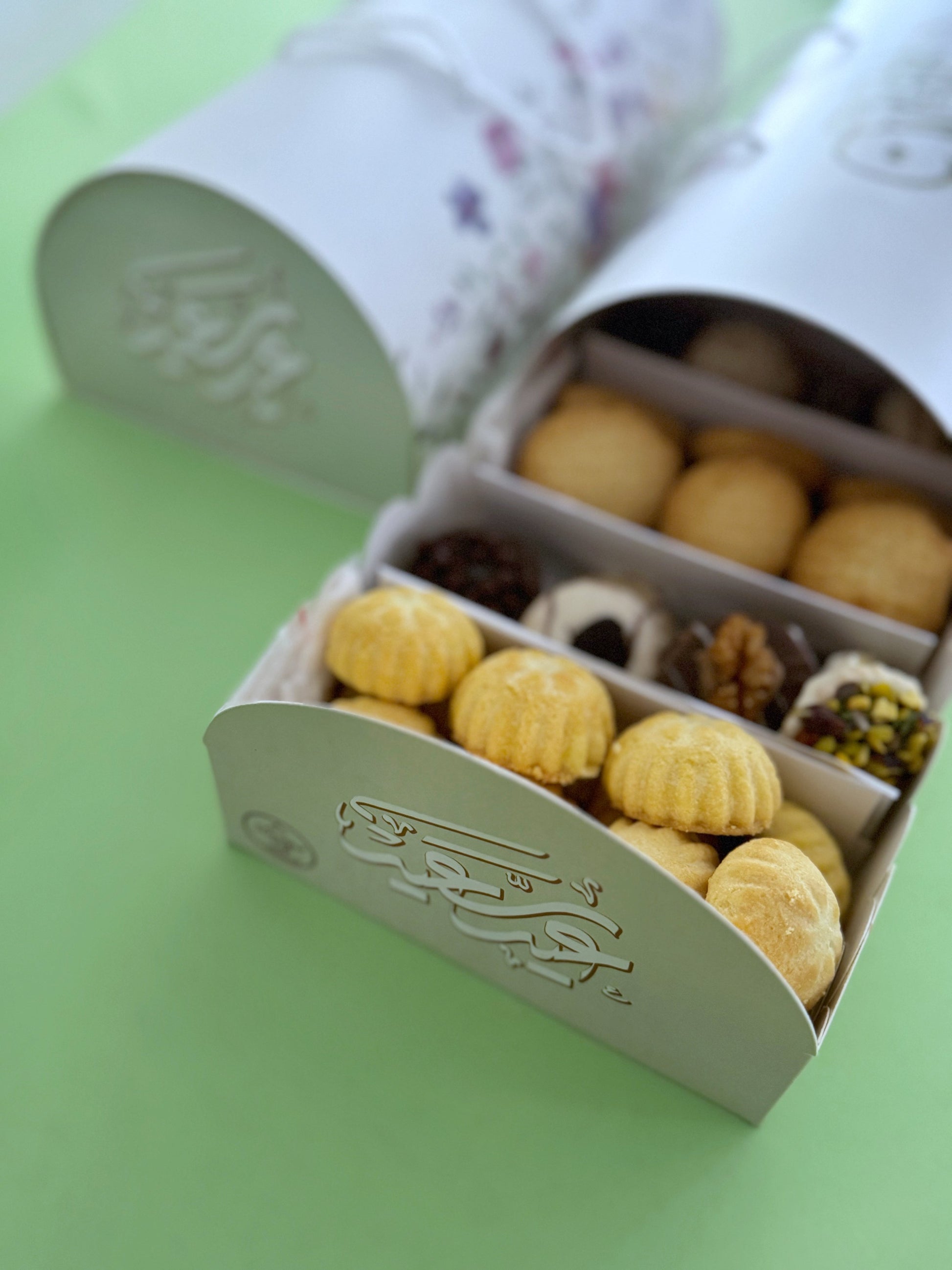 The Grand Kahk Box – Close-up of open tray showing Ghraybeh, Plain Kahk, and assorted Petit-Four with dark and white chocolate