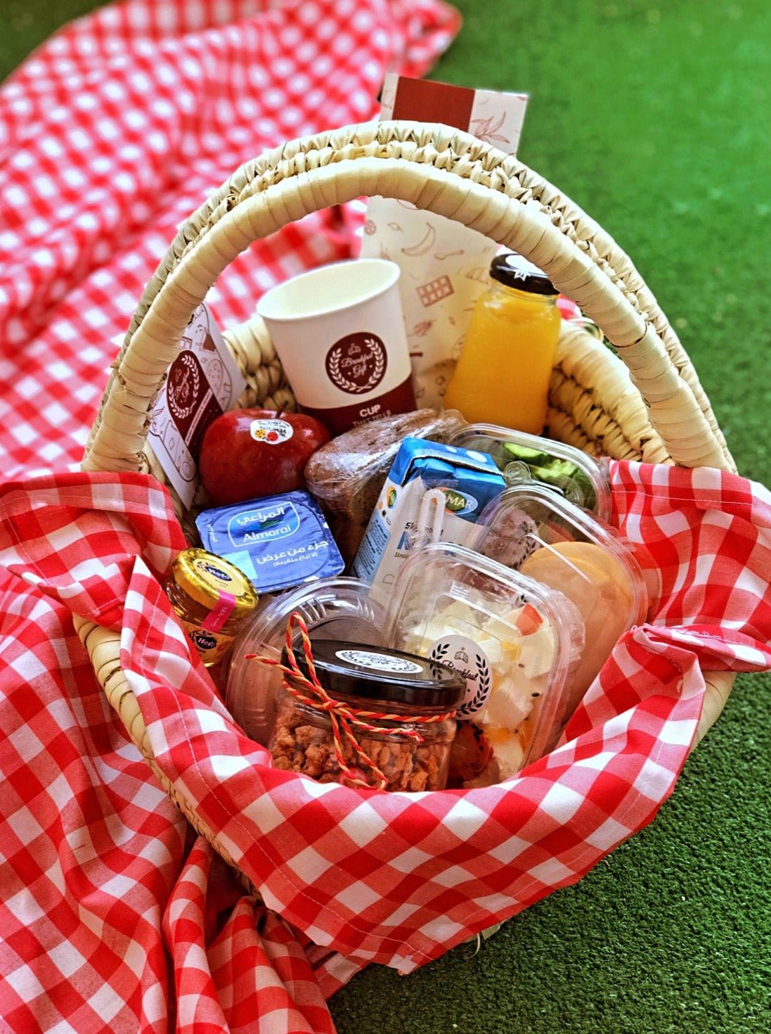Healthy Breakfast in a Basket gift set, featuring a wicker tray with granola, whole wheat toast, cheddar cheese, light cheese, fresh seasonal fruits, vegetables, a boiled egg, smoked chicken luncheon, honey, fresh milk, and sugar-free natural juice. A perfect nutritious gift for a balanced and healthy start to the day.