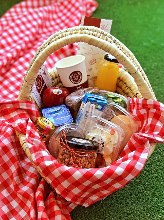 Healthy Breakfast in a Basket gift set, featuring a wicker tray with granola, whole wheat toast, cheddar cheese, light cheese, fresh seasonal fruits, vegetables, a boiled egg, smoked chicken luncheon, honey, fresh milk, and sugar-free natural juice. A perfect nutritious gift for a balanced and healthy start to the day.